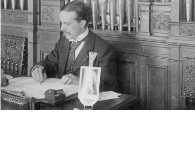 Louis Vierne in his Paris apartment at 62 rue des Saints-Pères, where he had settled around 1905. The photograph dates from around 1908.